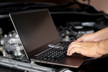Car service and technology concept, Technicians use laptop check service lists for car part mistakes and maintenance in engine room