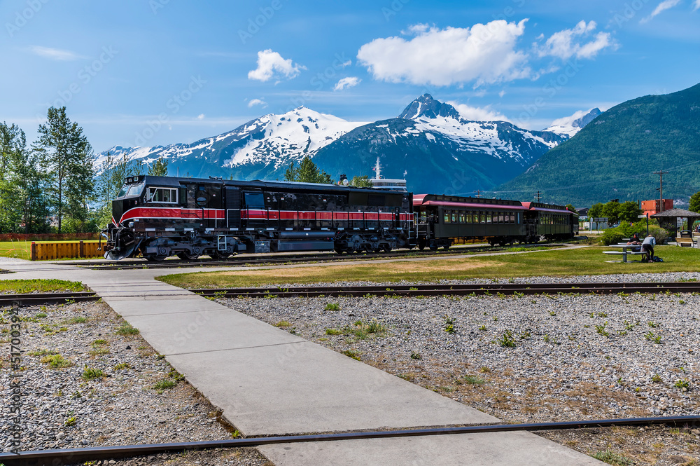 Wall mural A view of a train heading out on White Pass & Yukon Route Railway at Skagway, Alaska in summertime