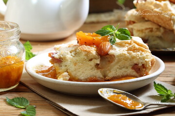Pie with apricots and mint tea on a wooden table