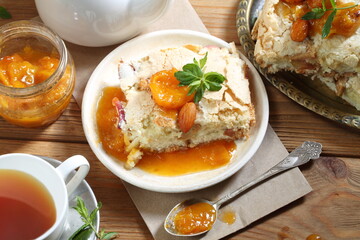 Pie with apricots and mint tea on a wooden table