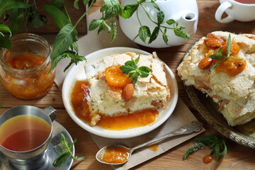 Pie with apricots and mint tea on a wooden table