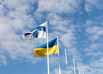 The flag of Ukraine and the Flag of Finland are flying in the sky. Assistance to Ukraine from Finland