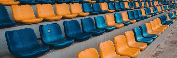 Fototapeta premium Rows of plastic seats at a stadium. Landscape picture at stadium.