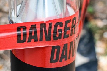 Closeup shot of red Danger warning tape - barricade barrier tape