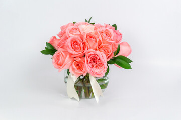 Vase of roses decorated with a list on white background