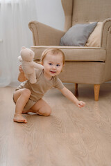 Fototapeta premium A funny baby crawling abnormally. Developmental milestones. Active toddler.