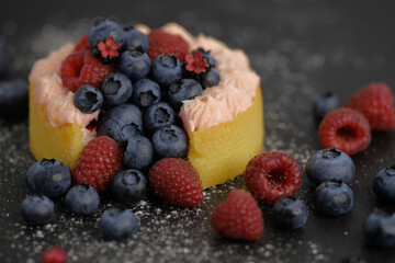 Cake with cream covered with juicy berries.