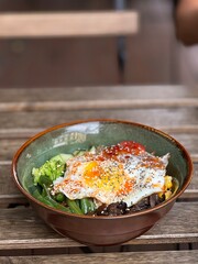 bowl with fried egg and vegetables
