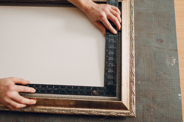 Restoration, measurement, renewal picture frame for museum painting art picture. Painting baguette handmade picture frame at studio.