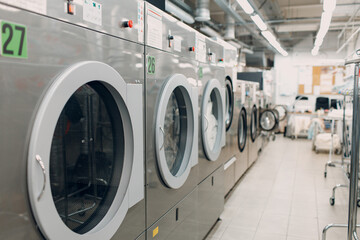 Dry cleaning with washing machine spin clothes. Clean cloth chemical process. Laundry industrial dry-cleaning