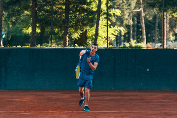 Obraz premium A professional tennis player is serving ball on a clay tennis court