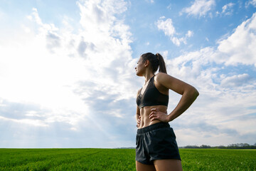 Girl athlete does warm-up outdoors, exercises for muscles.