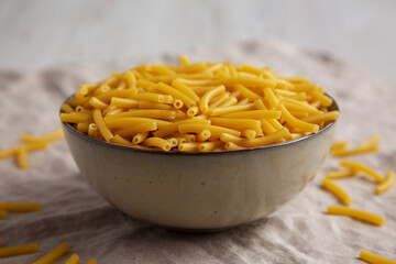 Dry Organic Maccheroni Pasta in a Bowl, side view. Close-up.