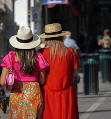 Fotobehang Back view of two female tourists enjoying the beauties of Palermo, Sicily © Michele Sicurella/Wirestock Creators
