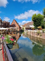 Vertical shot of atmospheric street entourage next to a river in Elsass, France