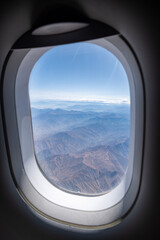 Fototapeta na wymiar The hazy Peruvian Andes Mountains seen from above in an airplane view