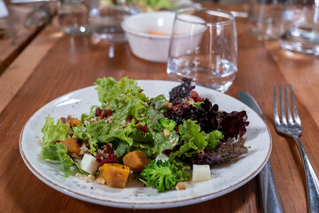 A fresh green salad with sweet potatoes