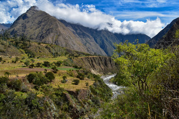 Fototapeta na wymiar Hiking in the cloud forests and green valleys of the Inca Trail on the way to Machu Picchu in Peru