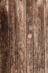 wooden wall made of longitudinal planks as a vertical background