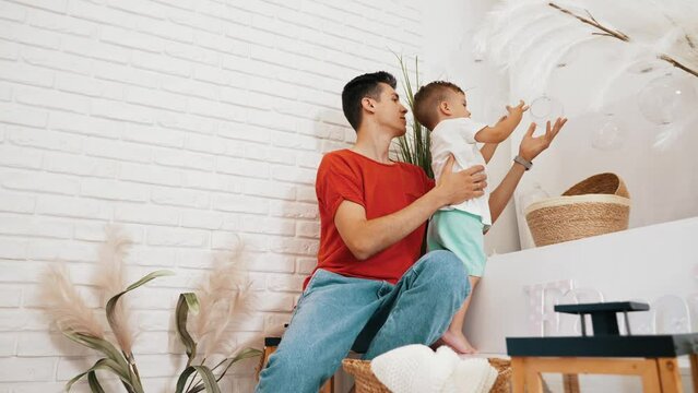 little boy enjoying with his father at home, children and parents concept. High quality 4k footage