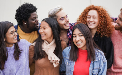 Group of happy multiracial friends enjoy day together in the city