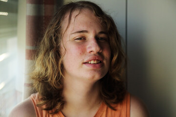 Portrait of a real teenager with long hair at home - 517031789