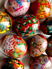 Vertical closeup shot of orthodox easter decorated eggs with illustrations of matryoshka