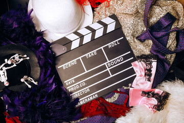 film industry, movie clapperboard, hats, boa, tie, lace, sequins, gloves.