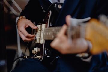 Shallow focus shot of a person playing an electric guitar
