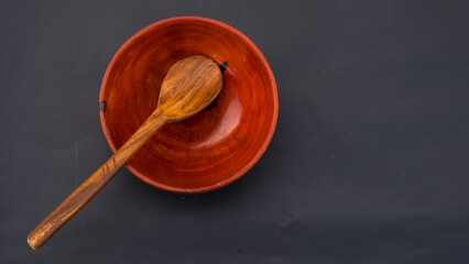Fototapeta na wymiar wooden bowl. wooden utensils. wooden spoon. bowl and spoon. bowl. spoon. Wooden Bowl and Spoon. empty space for text 