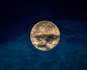 Los Angeles, CA, USA – July 14, 2022: A full moon starts its descent in the early morning hours above Los Angeles, CA.