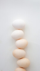 white and brown eggs on a white background