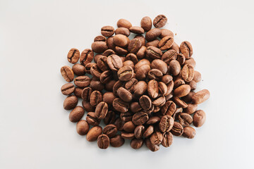 Roasted coffee beans isolated close up on white background, clipping path