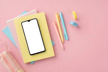 Back to school concept. Top view photo of school supplies smartphone over copybooks pens pencil-case and adhesive tape on isolated pink background with blank space