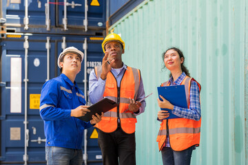 Asian workers working together at container yard warehouse.