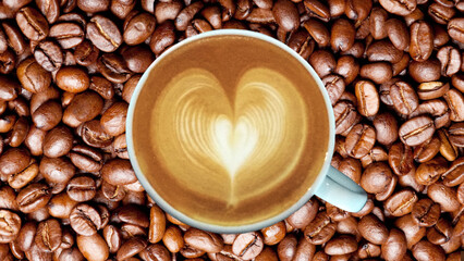 A Coffee Cup of Love.  Beautiful Heart Shape Latte Art Coffee in White Cup on Coffee Beans Background for The One You Love.