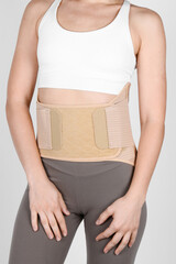 Orthopedic lumbar corset on the human body. Back brace, waist support belt for back. Posture...