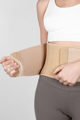 Orthopedic lumbar corset on the human body. Back brace, waist support belt for back. Posture Corrector For Back Clavicle Spine. Post-operative Hernia Pregnant and Postnatal Lumbar brace after surgery.