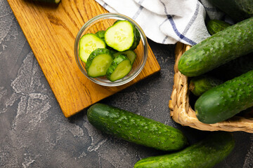 Fresh organic cucumbers against black marble background.Cucumber slices. Salad ingredient. Fresh vegetables. Vegan food. Healthy food. Fresh organic vegetables.
