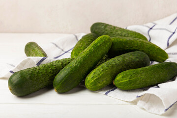 Fresh cucumbers on white texture wood. Vegetarian organic vegetables.Ingredient for salad. Healthy food.Copy space.Place for text