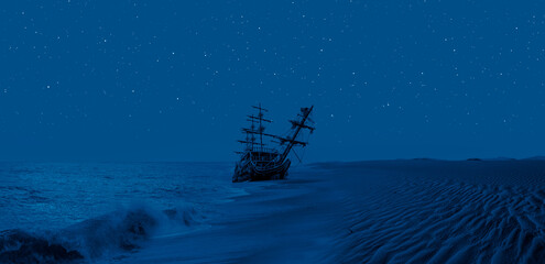 The thrown old ship has sat down on a bank at night - An old wooden ship  sitting on top of a sandy...