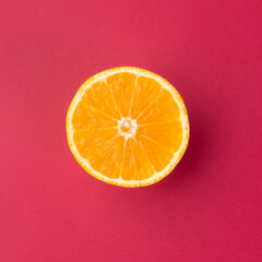 Orange half isolated over red textured background