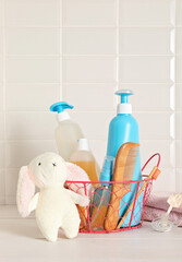 Set of baby toiletries, child organic hygiene and bath accessories, shower gel, shampoo, essential oil, towel in the bathroom