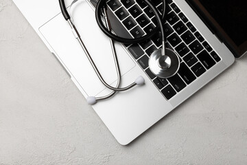 Healthcare and medicine.Computer antivirus protection and maintenance.Stethoscope on laptop keyboard.Modern medical technology and software advance the concept.Computer diagnostics and repair. flatley