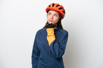 Young cyclist Lithuanian woman isolated on white background and looking up