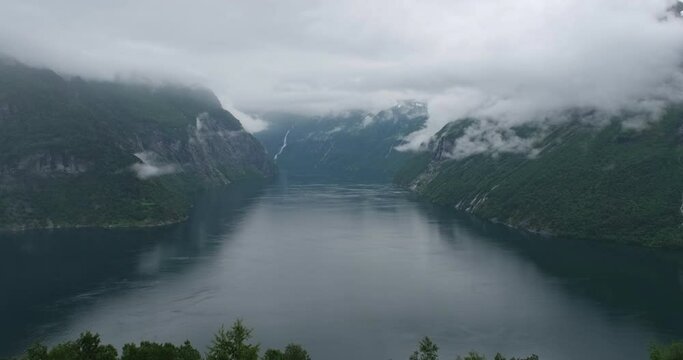 Wonderful landscapes in Norway. Beautiful scenery of Geiranger fjord from the viewpoint in More og Romsdal. Mountains in background. Summer rainy day. 4K UHD 59,94fps ProRes 422 HQ 10 bit