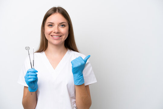 Dentist Woman Holding Tools Isolated On White Background Pointing To The Side To Present A Product