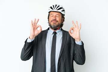 Business senior man with a bike helmet isolated on white background in zen pose