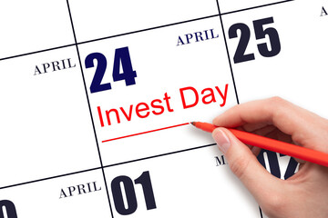 Hand drawing red line and writing the text Invest Day on calendar date April 24. Business and...