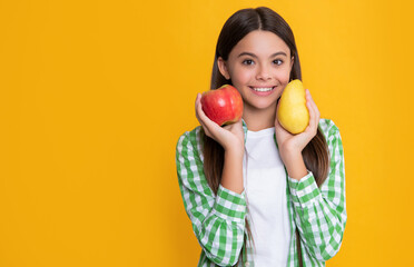 Fototapeta na wymiar happy kid with apple and pear fruit on yellow background
